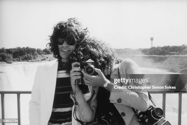 Singer Mick Jagger and photographer Annie Leibovitz pose at Niagara Falls during the Rolling Stones Tour of the Americas, 1975.
