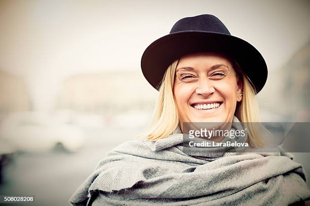 portrait of middle age laughing women on the street - 40 year old woman blonde blue eyes stock pictures, royalty-free photos & images