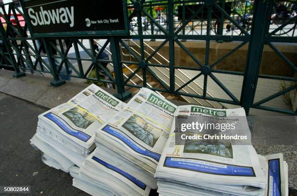 The first editions of Metro New York newspaper sit in stacks near a subway station May 5, 2004 in Union Sqaure in New York. Metro, a free daily...