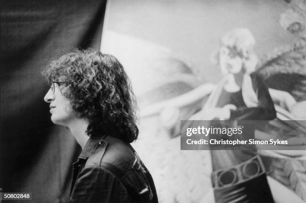American photographer Annie Leibovitz in front of a large picture of Mick Jagger during the Rolling Stones' 1975 Tour of the Americas.