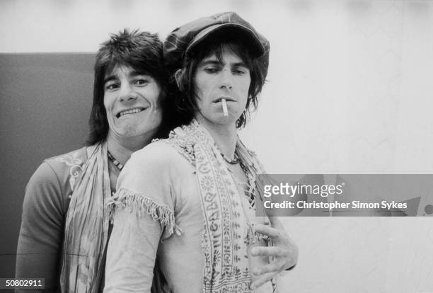 Jovial guitarist Ron Wood embraces his elegantly wasted colleague Keith Richards backstage during the Rolling Stones' 1975 Tour of the Americas.