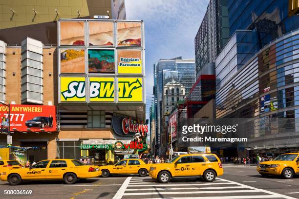 midtown, taxis in the 8th avenue - yellow taxi stock pictures, royalty-free photos & images