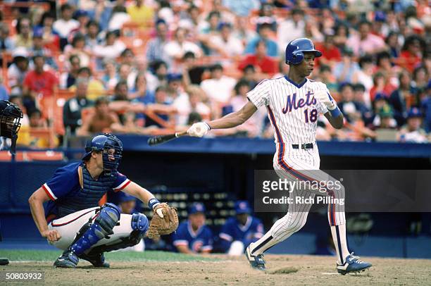 Darryl Strawberry of the New York Mets follows through on a swing during a 1984 season game against the Chicago Cubs at Shea Stadium in Flushing, New...