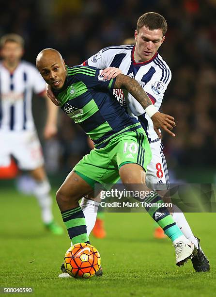 Andre Ayew of Swansea City and Craig Gardner of West Bromwich Albion compete for the ball during the Barclays Premier League match between West...