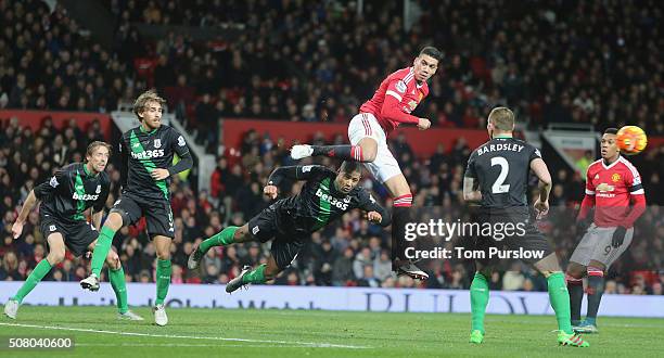 Chris Smalling of Manchester United in action with Glen Johnson of Stoke City during the Barclays Premier League match between Manchester United and...