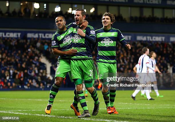 Gylfi Sigurdsson of Swansea City celebrates scoring his team's first goal with his team matesWayne Routledge and Alberto Paloschi during the Barclays...