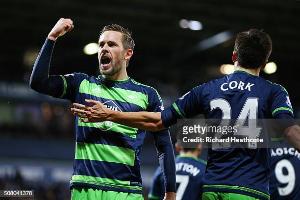 Gylfi Sigurdsson of Swansea City celebrates scoring his team's first goal with his team mate Jack Cork during the Barclays Premier League match...