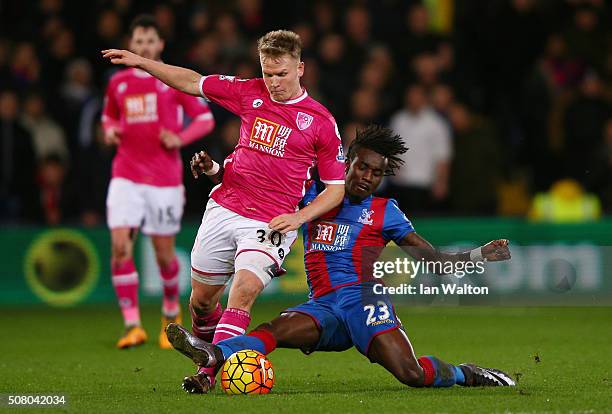 Matt Ritchie of Bournemouth is tackled by Pape N'Diaye Souare of Crystal Palace during the Barclays Premier League match between Crystal Palace and...