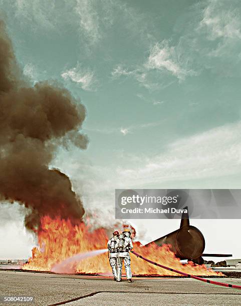 fire fighters during simulation training of plane - airplane fire stock pictures, royalty-free photos & images