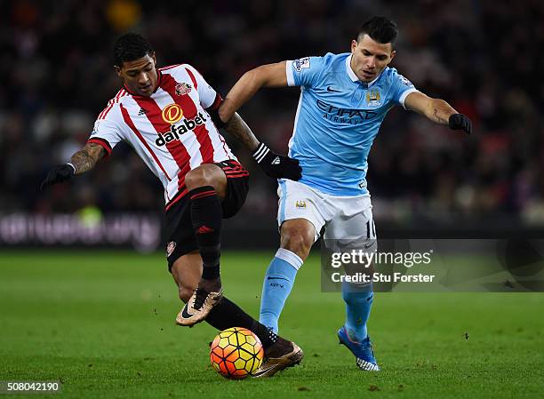 Sergio Aguero of Manchester City and Patrick van Aanholt of Sunderland compete for the ball during the Barclays Premier League match between...