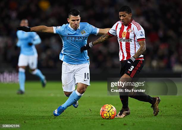 Sergio Aguero of Manchester City and Patrick van Aanholt of Sunderland compete for the ball during the Barclays Premier League match between...