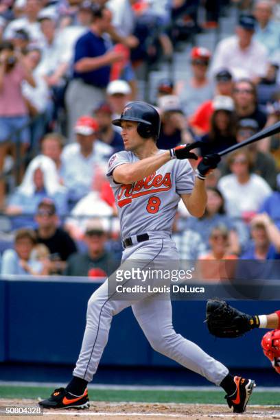 Cal Ripken Jr. #8 of the Baltimore Orioles watches the flight of the ball as he follows through on a swing during a game on June 14, 1997 against the...