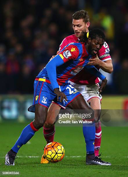 Emmanuel Adebayor of Crystal Palace and Simon Francis of Bournemouth compete for the ball during the Barclays Premier League match between Crystal...
