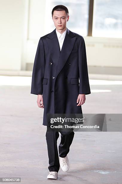 Model walks the runway wearing Duckie Brown during New York Fashion Week Men's Fall/Winter 2016 at Skylight at Clarkson Sq on February 2, 2016 in New...