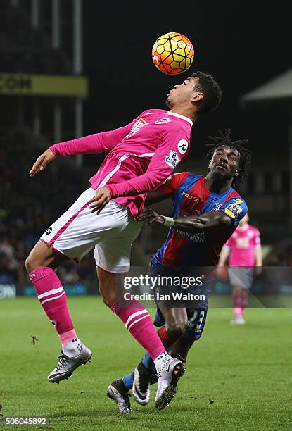 Joshua King of Bournemouth and Pape N'Diaye Souare of Crystal Palace compete for the ball during the Barclays Premier League match between Crystal...