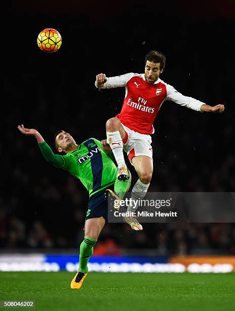 Mathieu Flamini of Arsenal and Dusan Tadic of Southampton compete for the ball during the Barclays Premier League match between Arsenal and...