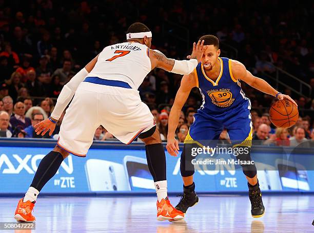 Stephen Curry of the Golden State Warriors draws a foul in the second half against Carmelo Anthony of the New York Knicks at Madison Square Garden on...