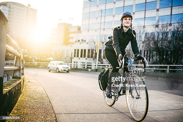bike commuter in portland oregon - cycling helmet stock pictures, royalty-free photos & images