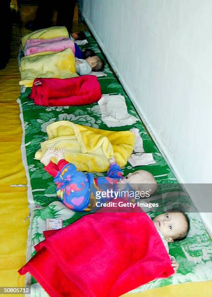 In this handout photo from the World Food Programme young children rest at a North Korea orphanage on April 23, 2004 in Chungjin, North Korea. Aid...