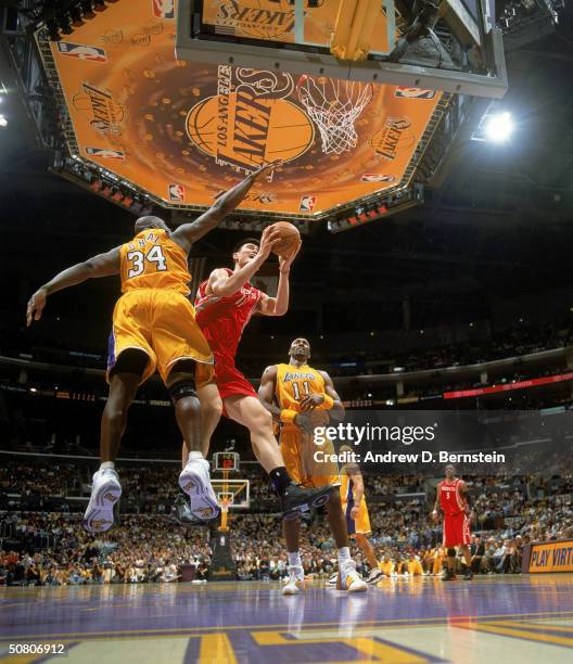 Yao Ming of the Houston Rockets looks to shoot under Shaquille O'Neal of the Los Angeles Lakers in Game five of the Western Conference Quarterfinals...
