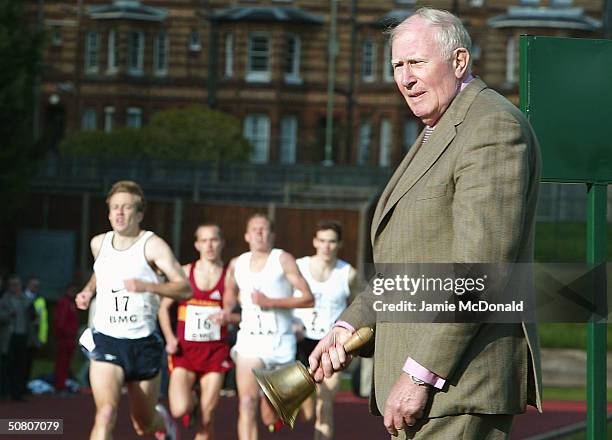 Sir Roger Bannister rings the Bell to signal the last lap of the mens elite 1500m race at the Iffley Road running track to celebrate the 50th...