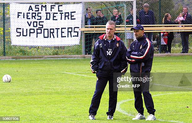 Monaco's French trainer Didier Deschamps and Italian fitness coach Antonio Pintus watch their team during a training session the day after their...