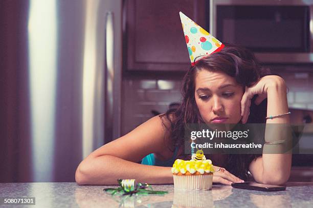 melancholy woman at home celebrating her birthday all alone - woman birthday stock pictures, royalty-free photos & images