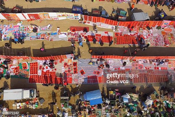 People purchase stuffs in preparation for the upcoming Spring Festival at a country fair on February 2, 2016 in Rizhao, Shandong Province of China....