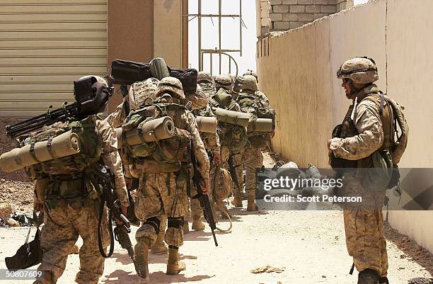 Marines of 2nd Battalion 1st Marine Regiment relieve a fellow platoon as they maintain their cordon at the key flashpoint Fallujah railway station on...