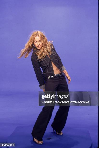 American pop singer Madonna dances in front of a blue screen during the video shoot for her single 'Ray Of Light,' 1998.