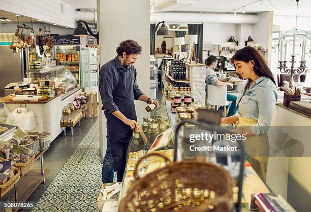 salespeople working in supermarket - cheesy salesman stock-fotos und bilder