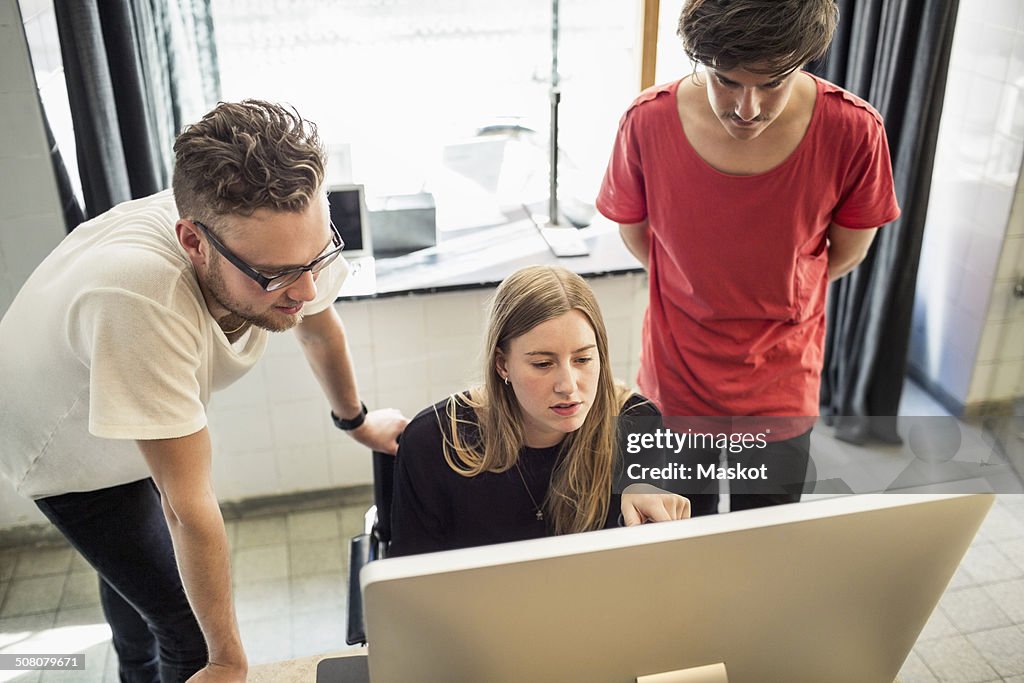 New business team working on computer in creative office