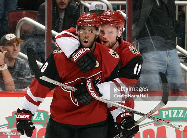 Anthony Duclair of the Arizona Coyotes celebrates with teammate Max Domi after his second period goal against the Los Angeles Kings at Gila River...