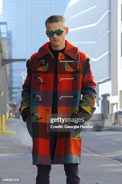 Everett Williams seen at Skylight Clarkson Sq outside the Duckie Brown show wearing multi colored vintage pea coat, Acne Studios pants and Rag & Bone...