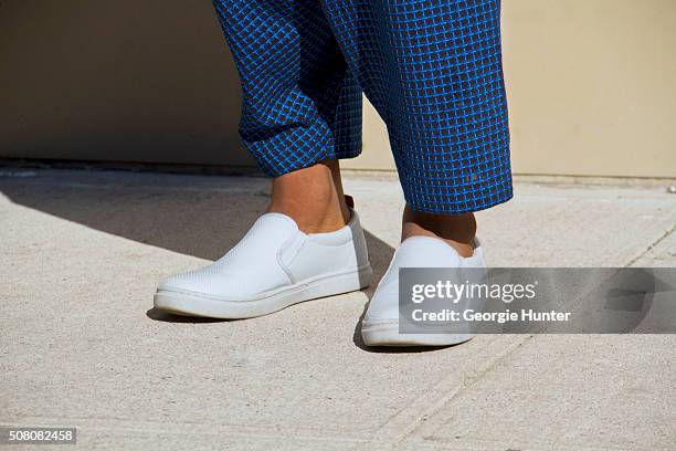 Hasani Arnold seen at Milk Studios outside the Public School show wearing blue Issey Miyake pants and Steve Madden white plimsolls during New York...