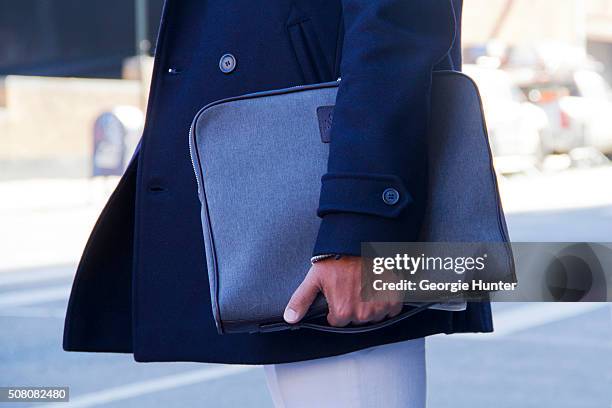 Guest seen at Skylight Clarkson Sq outside the Duckie Brown show wearing blue pea coat and clutch bag during New York Fashion Week: Men's Fall/Winter...