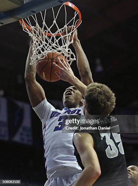 Rashaun Stimage of the DePaul Blue Demons dunks over Ryan Fazekas of the Providence Friars at Allstate Arena on January 30, 2016 in Rosemont,...