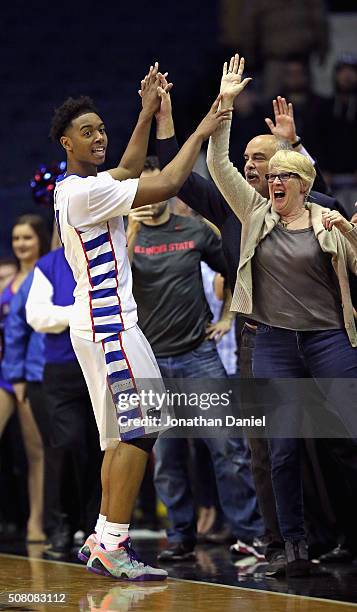 Eli Cain of the DePaul Blue Demons celebrates an upset win over the Providence Friars with fans at Allstate Arena on January 30, 2016 in Rosemont,...