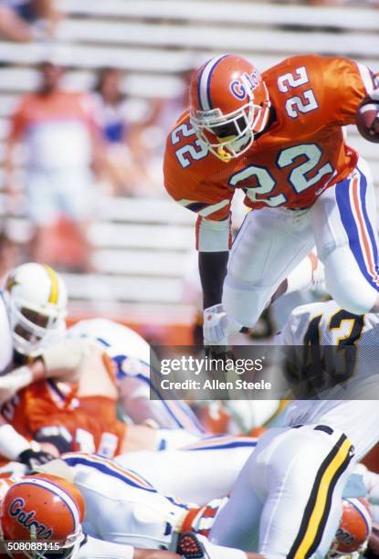 Running back Emmitt Smith of the Florida Gators jumps over the pile with the ball during a game against theVanderbilt Commodores at Ben Hill Griffin...