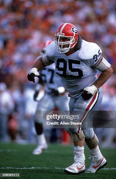 Bill Goldberg of the Georgia Bulldogs runs on the field during a game against the Florida Gators on November 5, 1988 at Ben Hill Griffin Stadium in...
