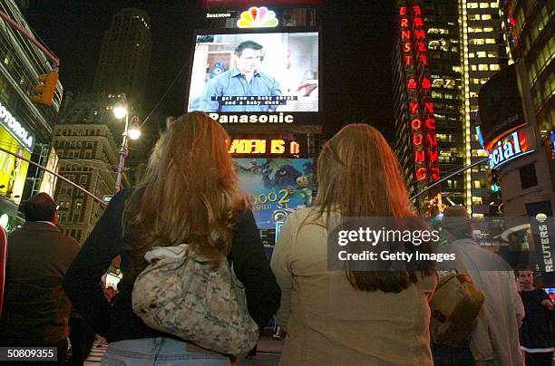 Crowd of New Yorkers watch the "Friends" finale being broadcast live on the Astrovision video screen in Times Square May 6, 2004 in New York City.