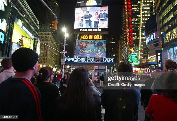 Crowd of New Yorkers watch the "Friends" finale being broadcast live on the Astrovision video screen in Times Square May 6, 2004 in New York City.