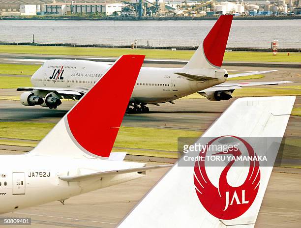 Japanese flagship air carrier Japan Airline System jetliner taxis at the Tokyo International Airport, 07 May 2004. JAL posted a huge loss for the...