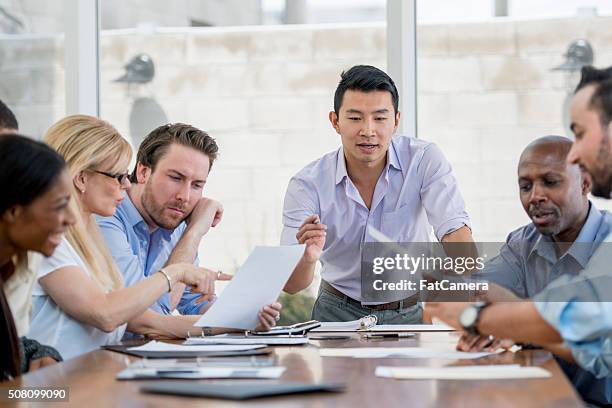 boardroom presentation - fat woman sitting on man 個照片及圖片檔