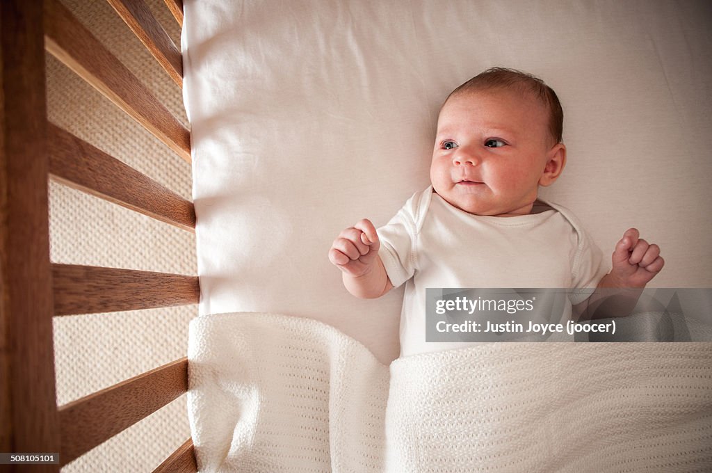 Infant (1 month) laying in crib