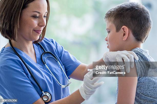 little boy getting a vaccine - influenza vaccination stock pictures, royalty-free photos & images