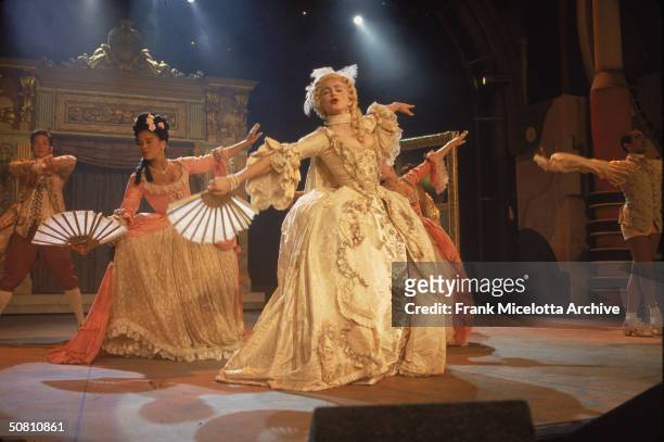American pop singer Madonna performs her single 'Vogue,' with a group of dancers, on the '1990 MTV Video Music Awards' show, New York, New York,...