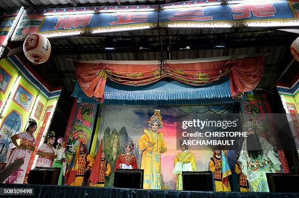 This picture taken on January 19, 2016 shows Chinese opera artists on stage during a performance held in a village in Nakhon Pathom province, west of...