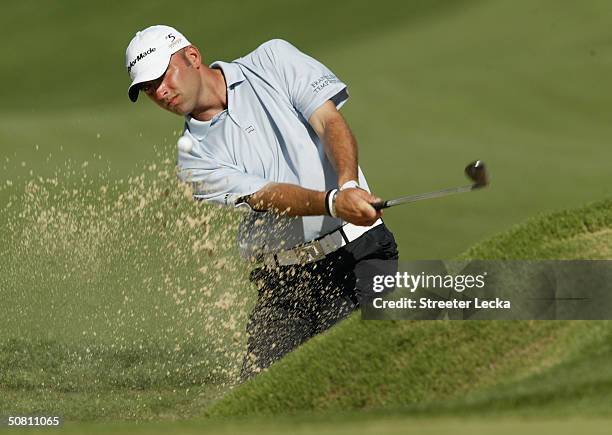 Hank Kuehne plays a bunker shot on the fourth hole during the second round of the Wachovia Championship at the Quail Hollow Club on May 7, 2004 in...