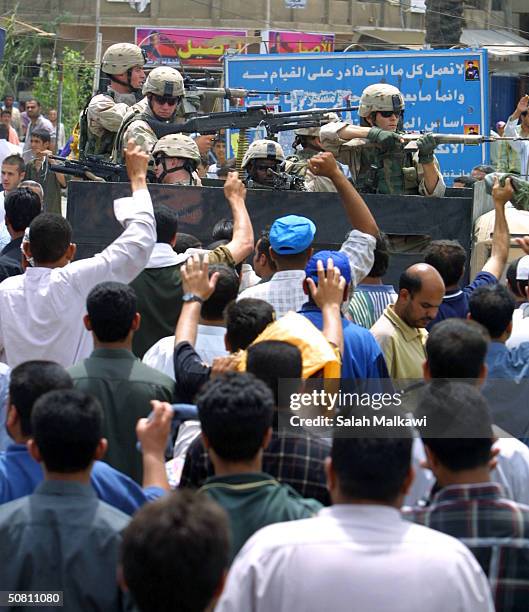 American soldiers patrol the streets during a joint Friday prayer between Sunni and Shias May 7, 2004 in Baghdad, Iraq. More than approximately ten...